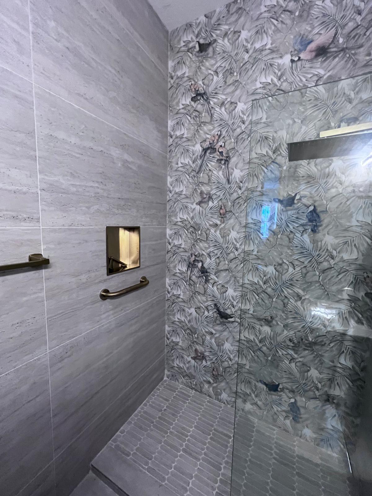Spa shower with travertine walls and tropical mural accent