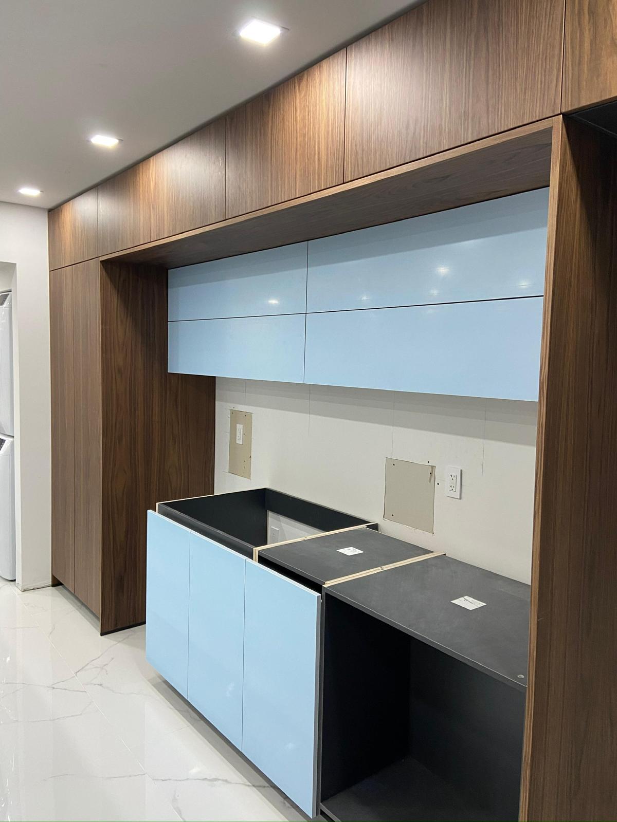 Walnut and sky-blue lacquer kitchen with stone counters