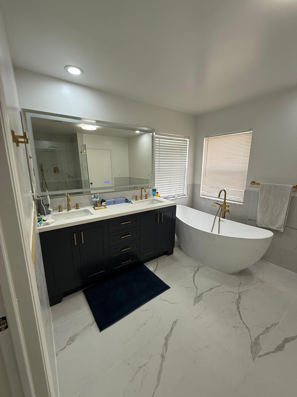 Master bath with freestanding tub, double vanity and gold fixtures