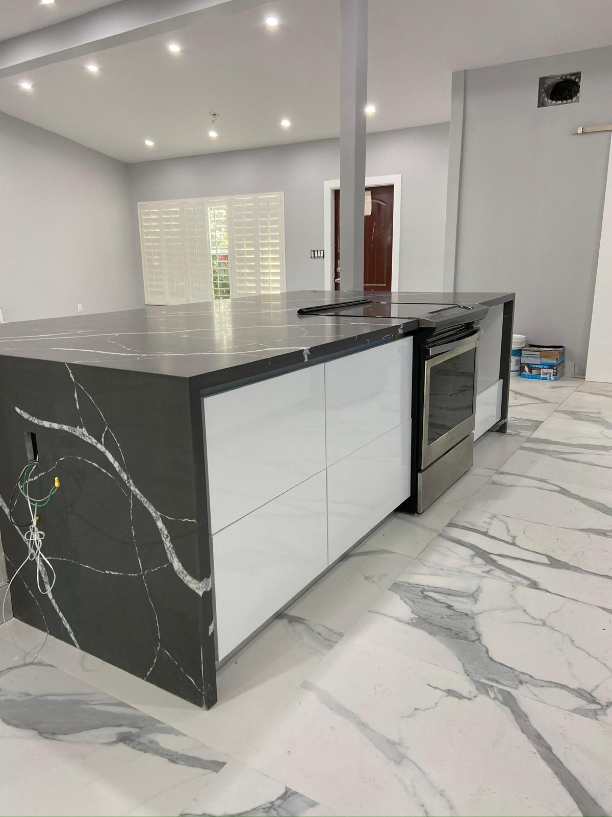 Waterfall quartz island with gloss white cabinetry