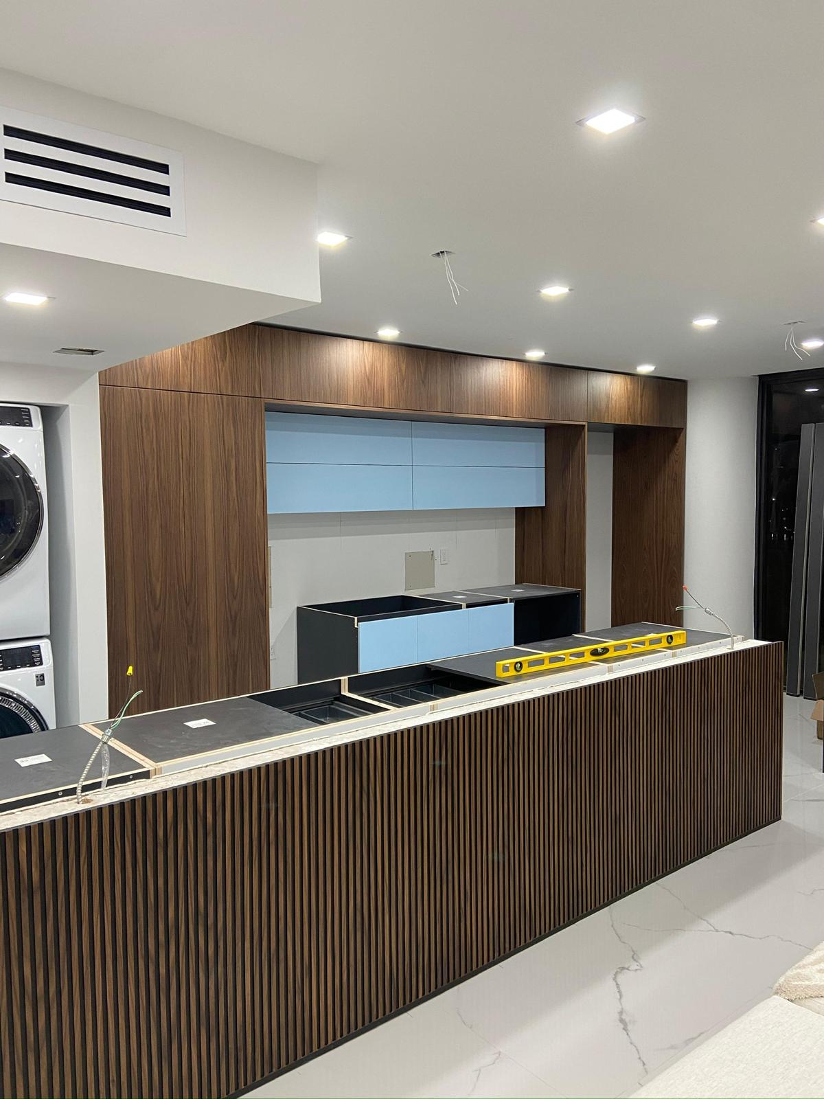 Walnut kitchen with fluted island front and porcelain counters